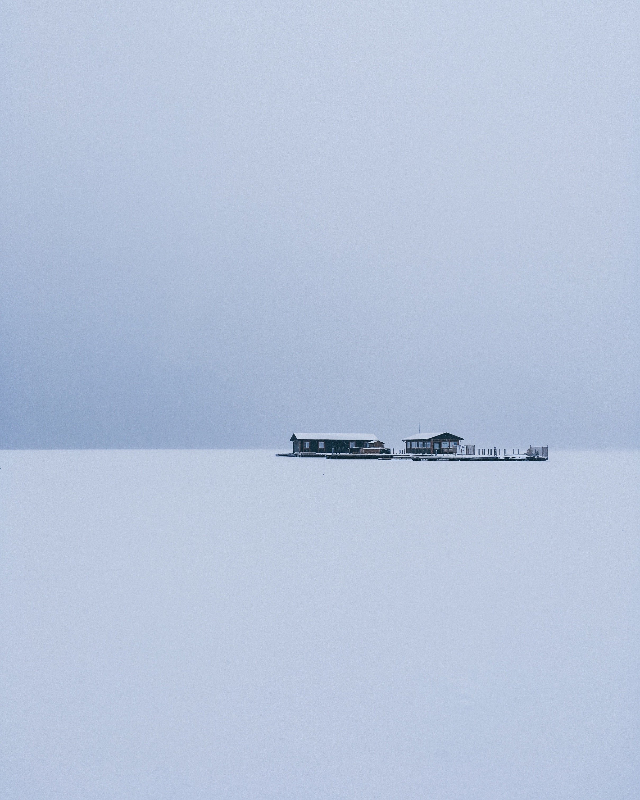 Photo of a person's home and frozen lake covered in snow